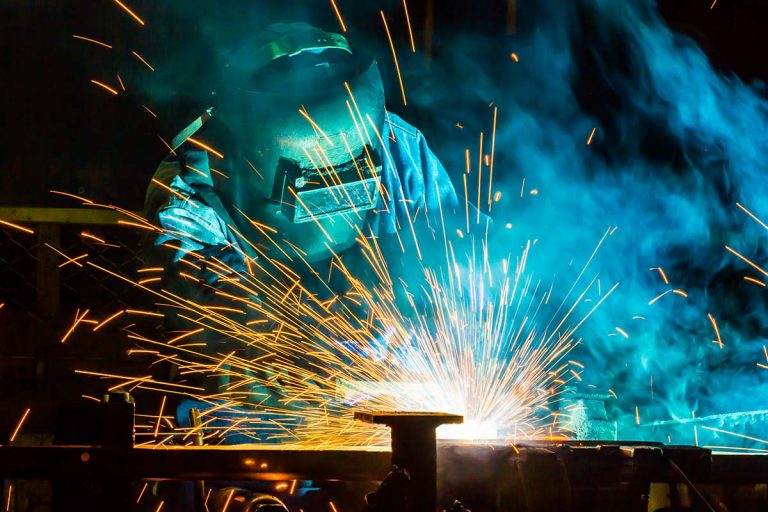 Photo of worker welding steel